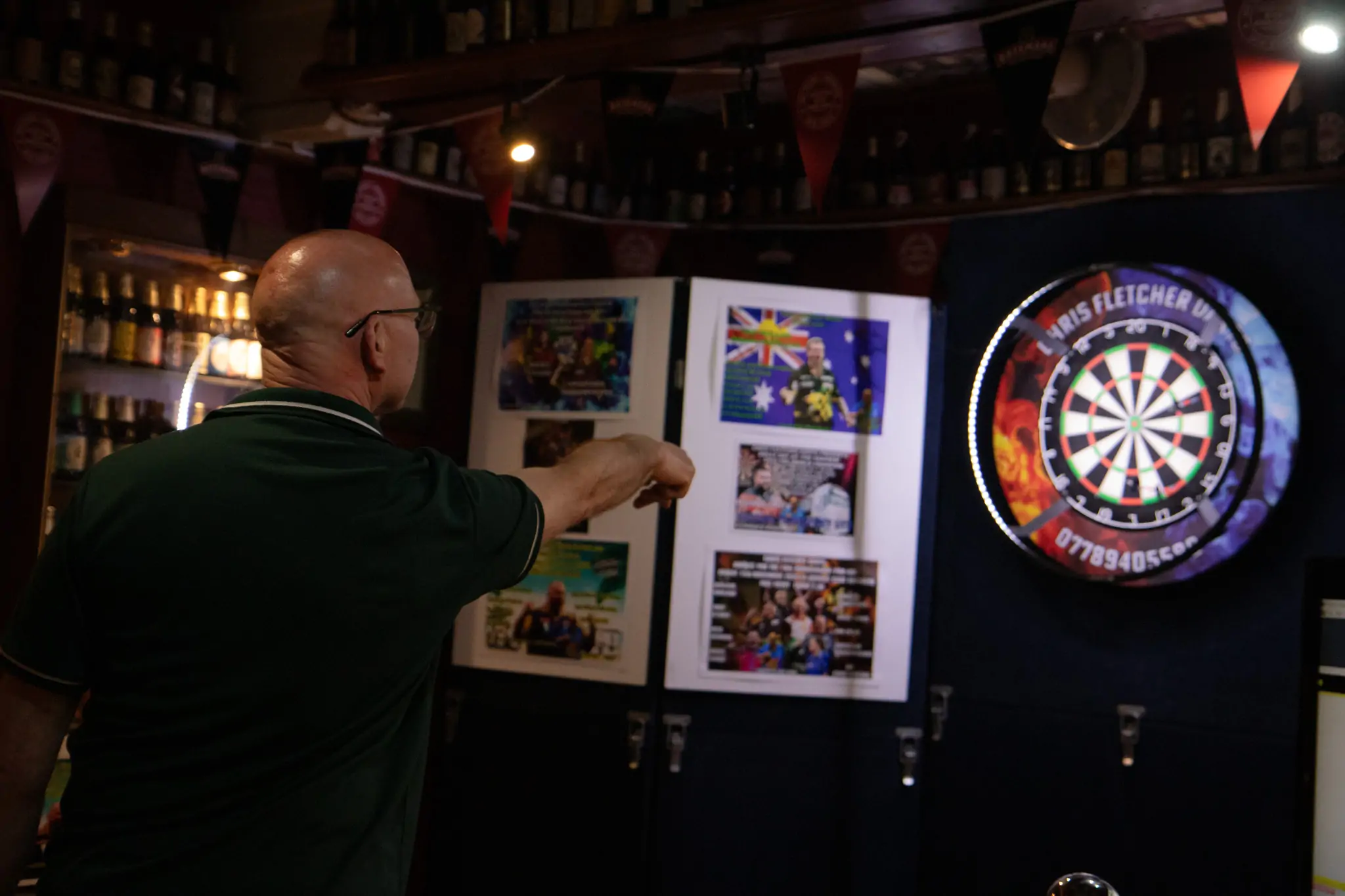 Peter Manley Pro Darts Player at the Batemans 150th anniversary celebrations darts with one of the competitors.