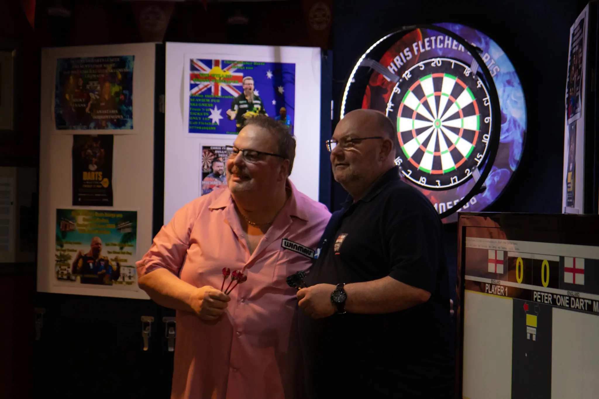 Peter Manley Pro Darts Player at the Batemans 150th anniversary celebrations darts with one of the competitors.