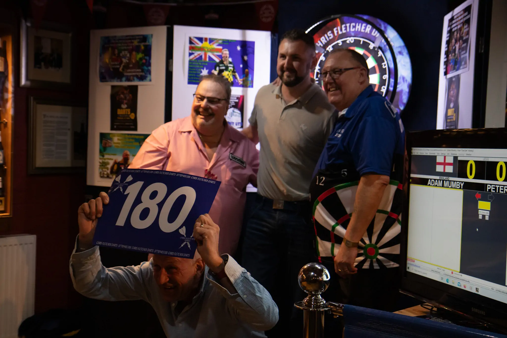 Peter Manley Pro Darts Player at the Batemans 150th anniversary celebrations darts with one of the competitors and Chris Fletcher.