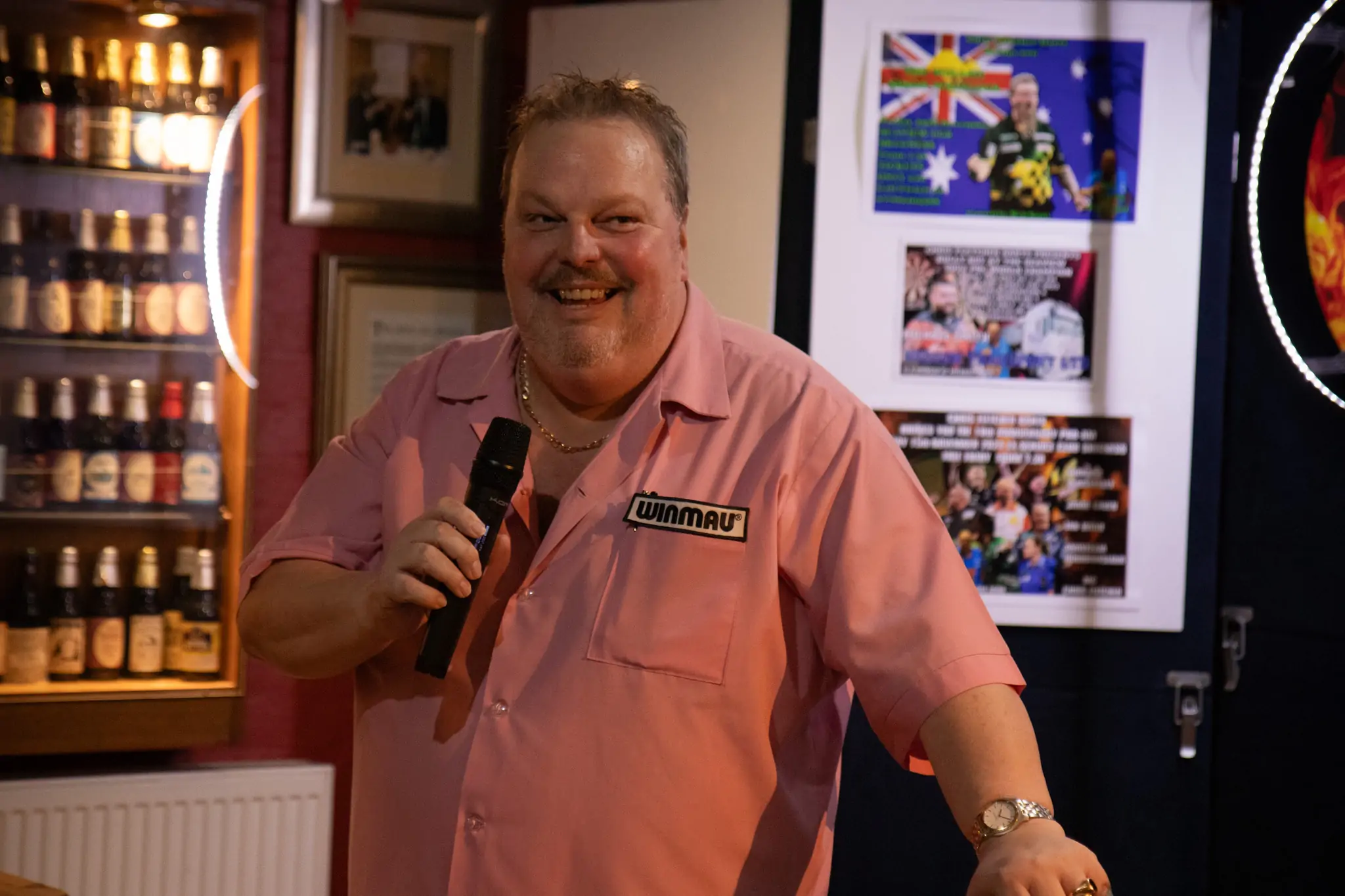 Peter Manley Pro Darts Player at the Batemans 150th anniversary celebrations darts competition talking on a microphone.